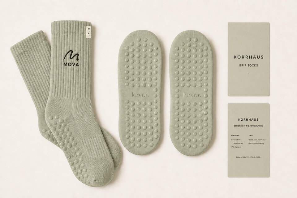 MOVA sage KORRHAUS grip socks with an embroidered studio logo, KORRHAUS grip soles and care wraps